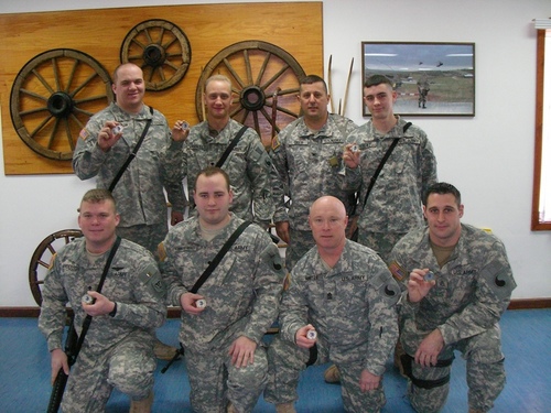 Military unit group holding challenge coins